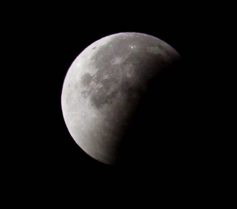 EXTREME CLOSE UP OF MOON IN DARK BACKGROUND