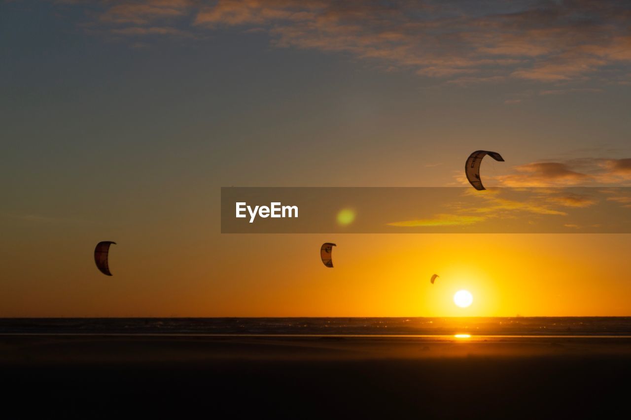 SCENIC VIEW OF SUNSET OVER BEACH