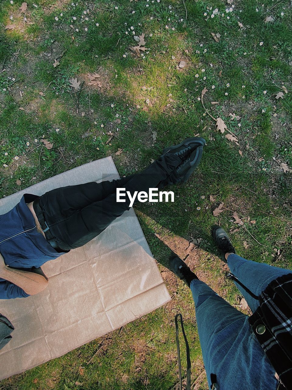 Low section of guy standing on grass