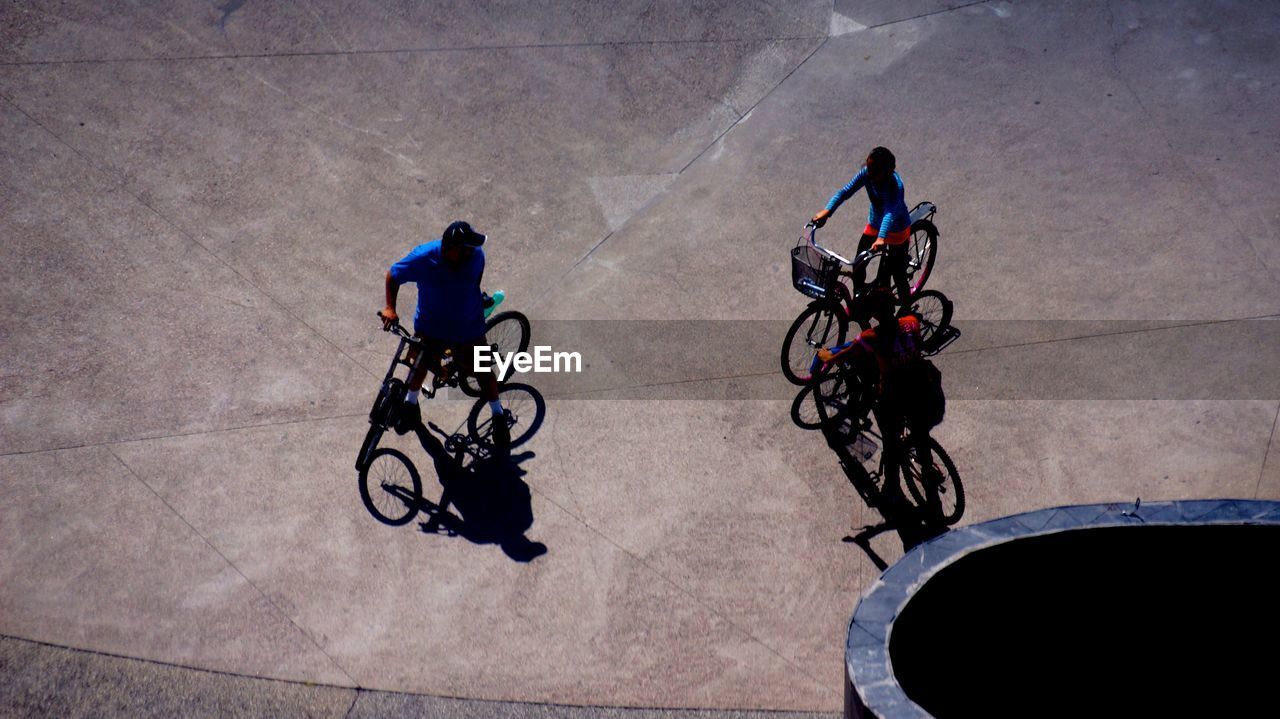 High angle view of friends with bicycles on street