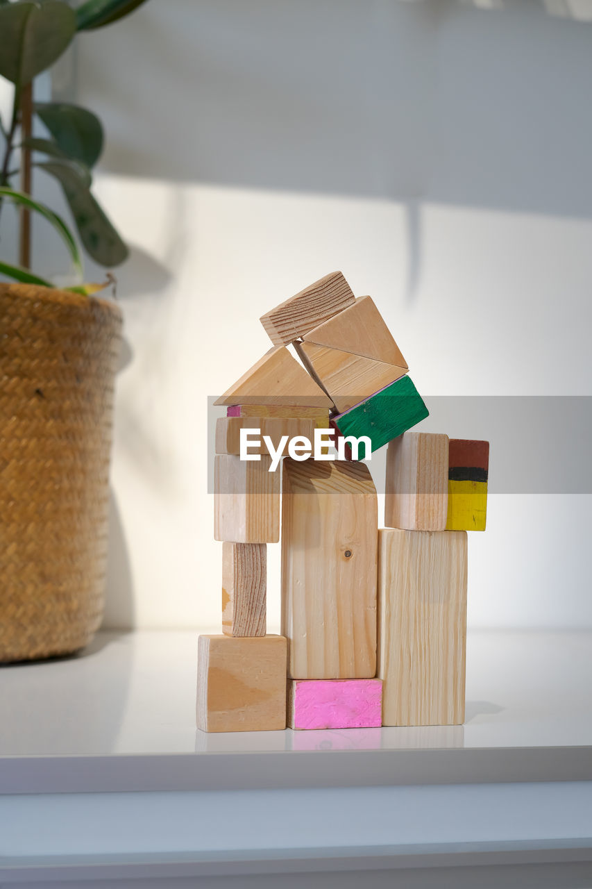 Wooden block toy house on a white background. conceptual image of acquisition of housing.