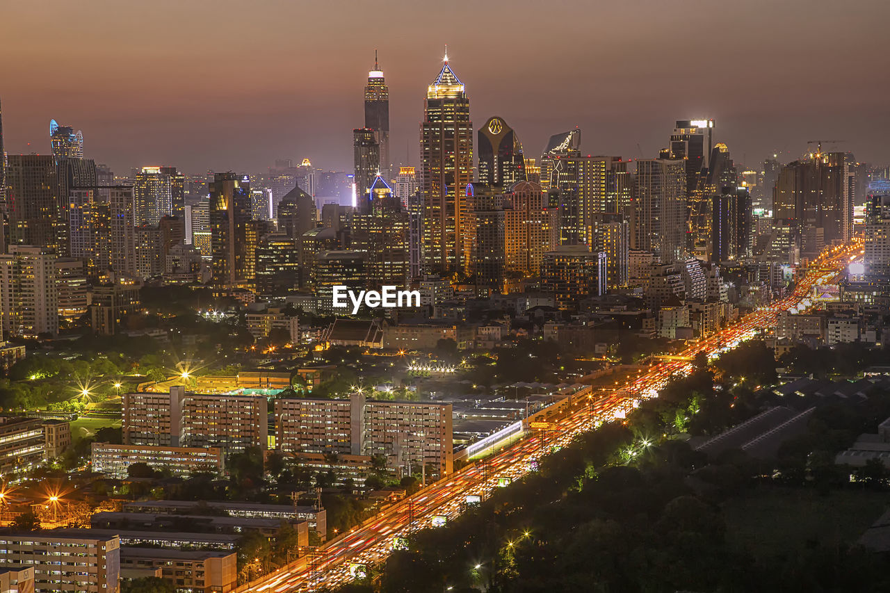 AERIAL VIEW OF ILLUMINATED CITY BUILDINGS AT NIGHT