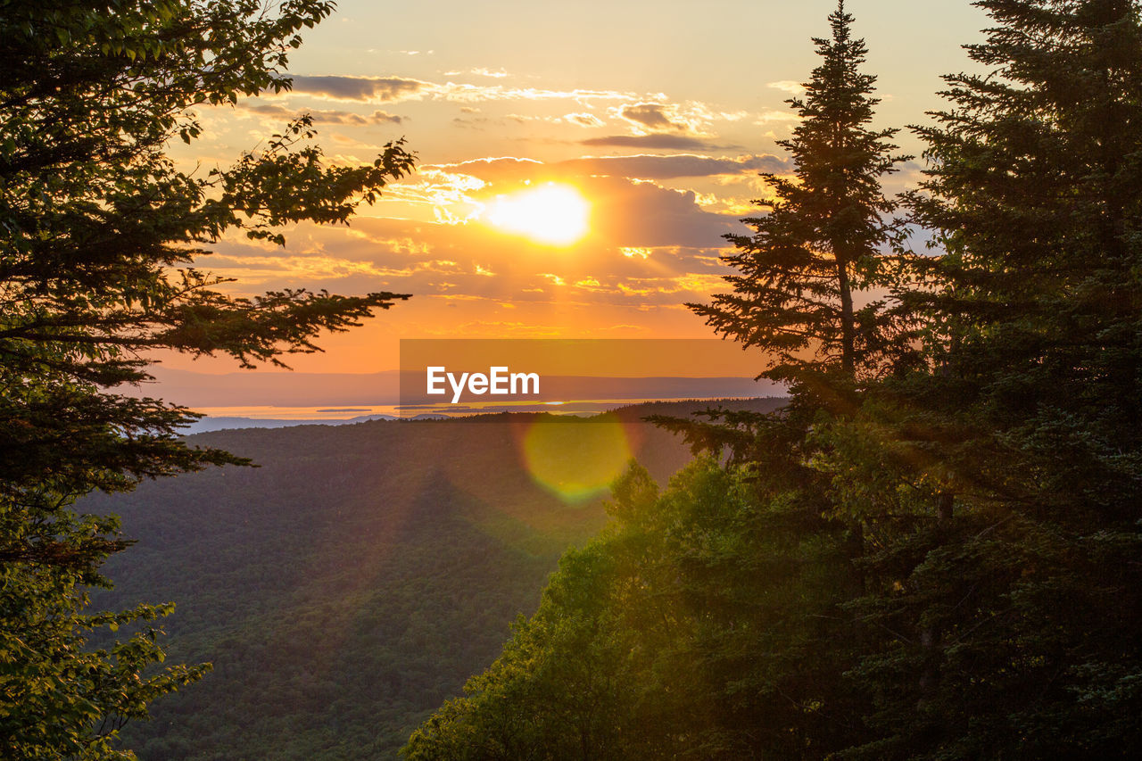 Scenic view of lake against sky at sunset