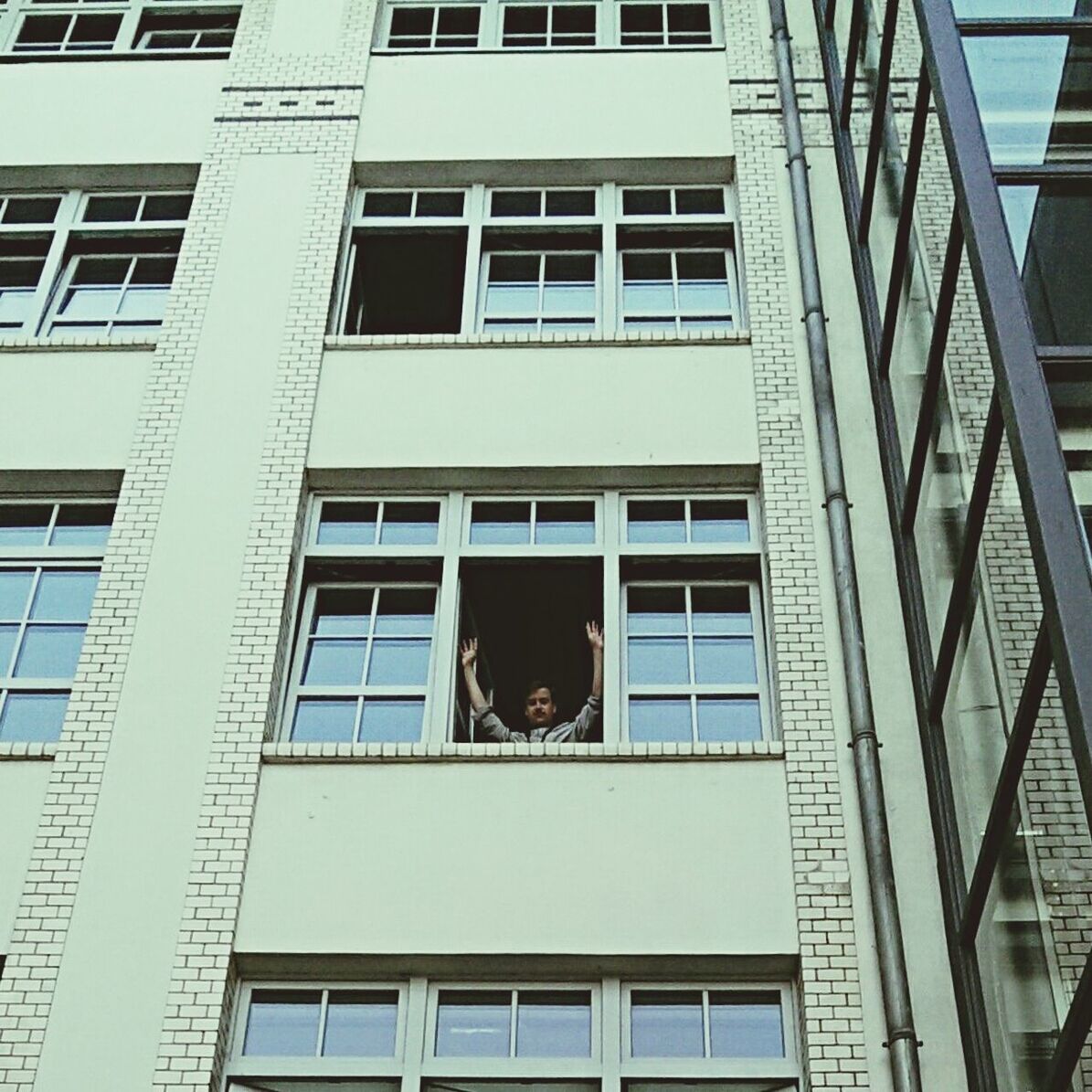 Man waving from window