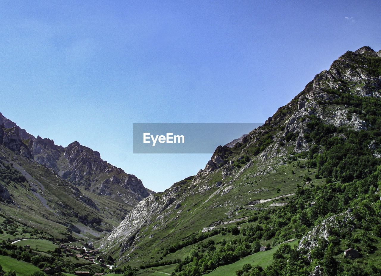 mountain, scenics - nature, sky, beauty in nature, mountain range, environment, landscape, nature, land, plant, tranquility, no people, tranquil scene, non-urban scene, valley, tree, mountain pass, clear sky, travel destinations, travel, green, rock, pinaceae, outdoors, day, idyllic, blue, tourism, ridge, coniferous tree, pine tree, plateau, forest, highland, wilderness, pine woodland