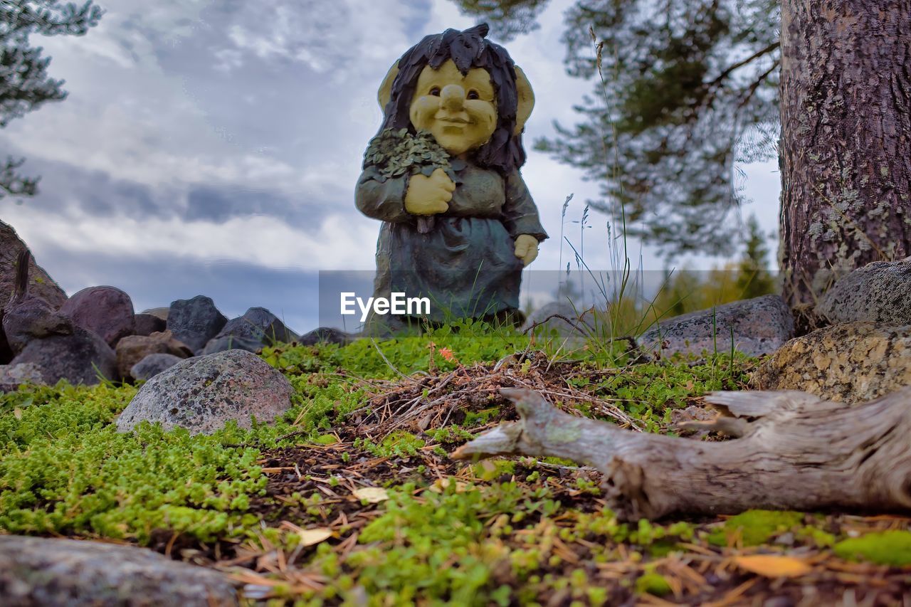 STATUE ON FIELD BY TREES