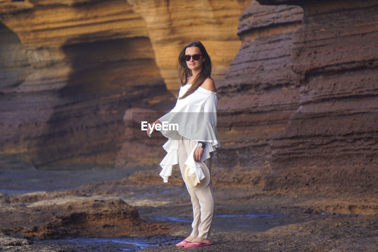 Portrait of woman wearing sunglasses at beach