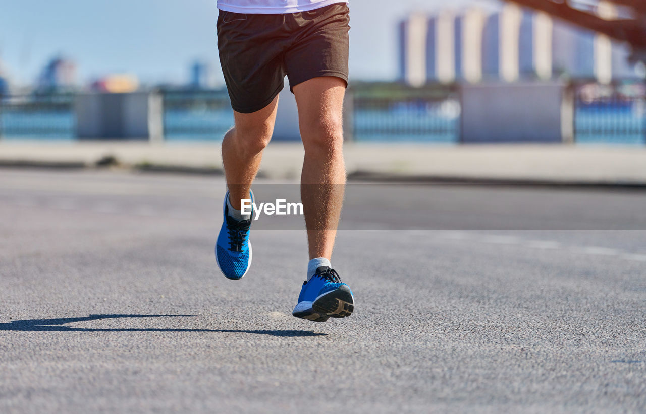 LOW SECTION OF MAN RUNNING ON STREET