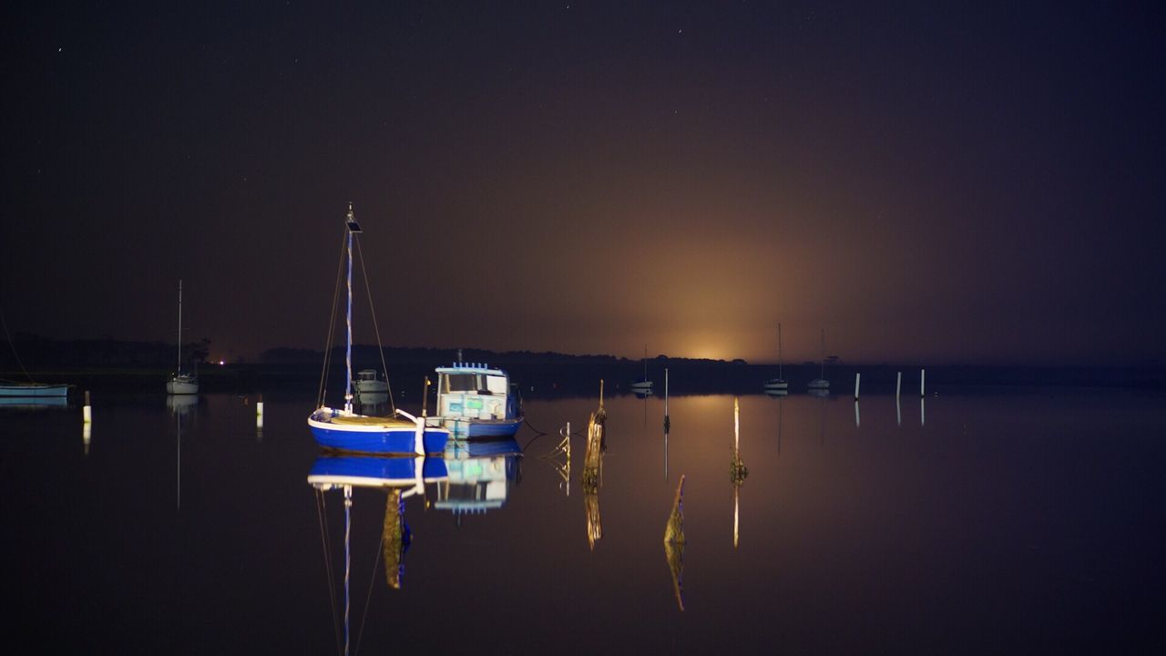 SAILBOATS MOORED IN SEA