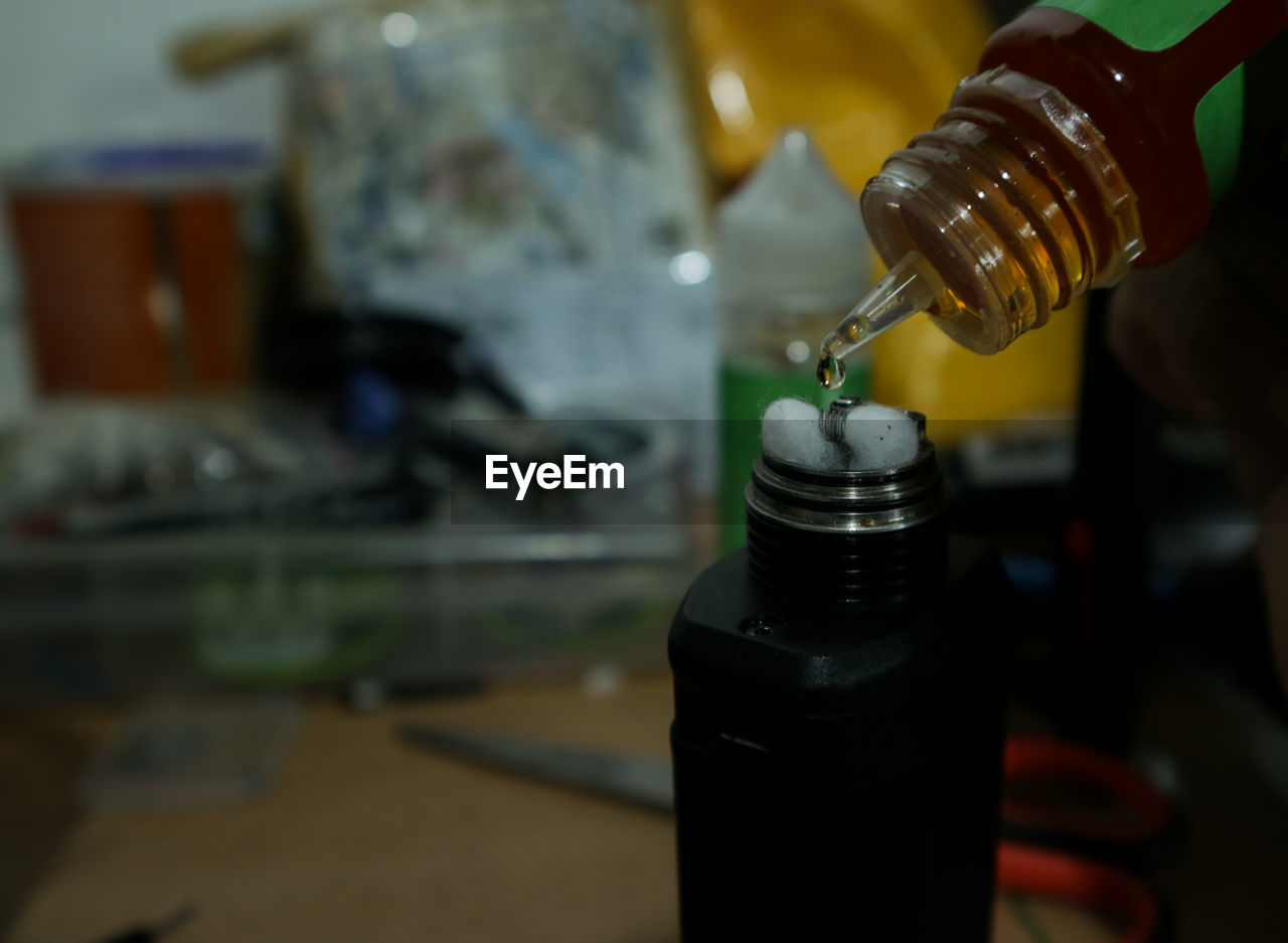 Close-up of liquid dripping in bottle