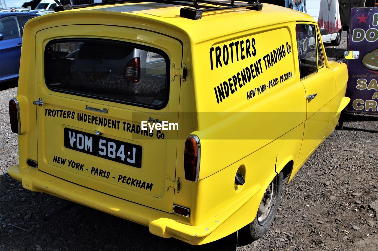 CLOSE-UP OF YELLOW TEXT ON CAR