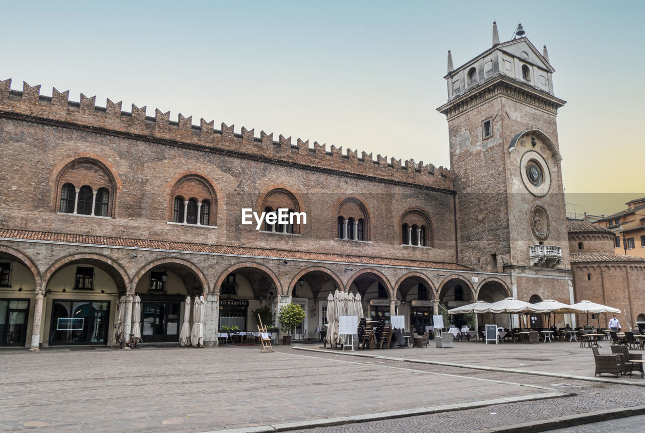  the square of erbe in mantua with historical buildings and a beautiful clock tower