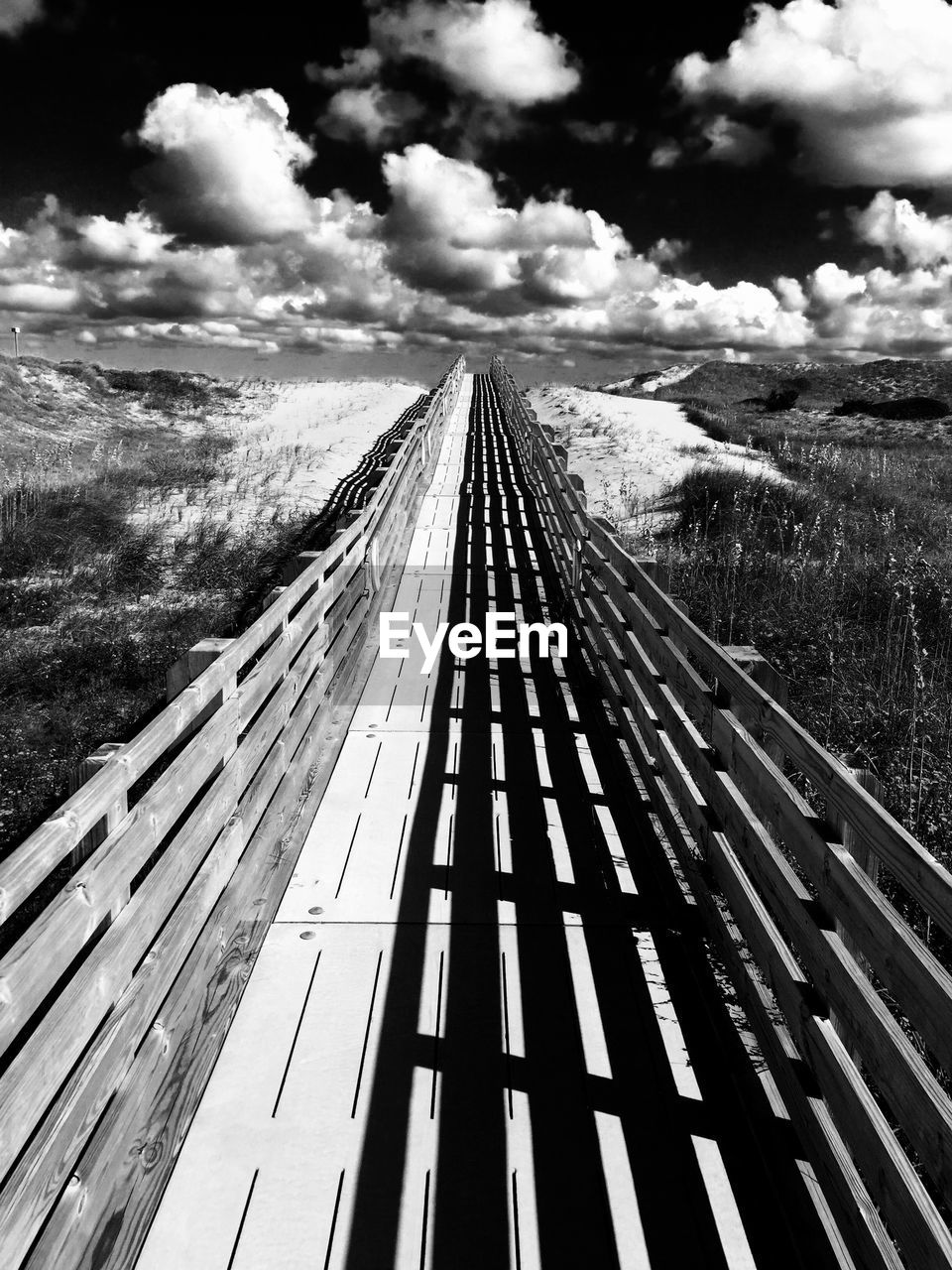 Boardwalk leading towards beach on sunny day