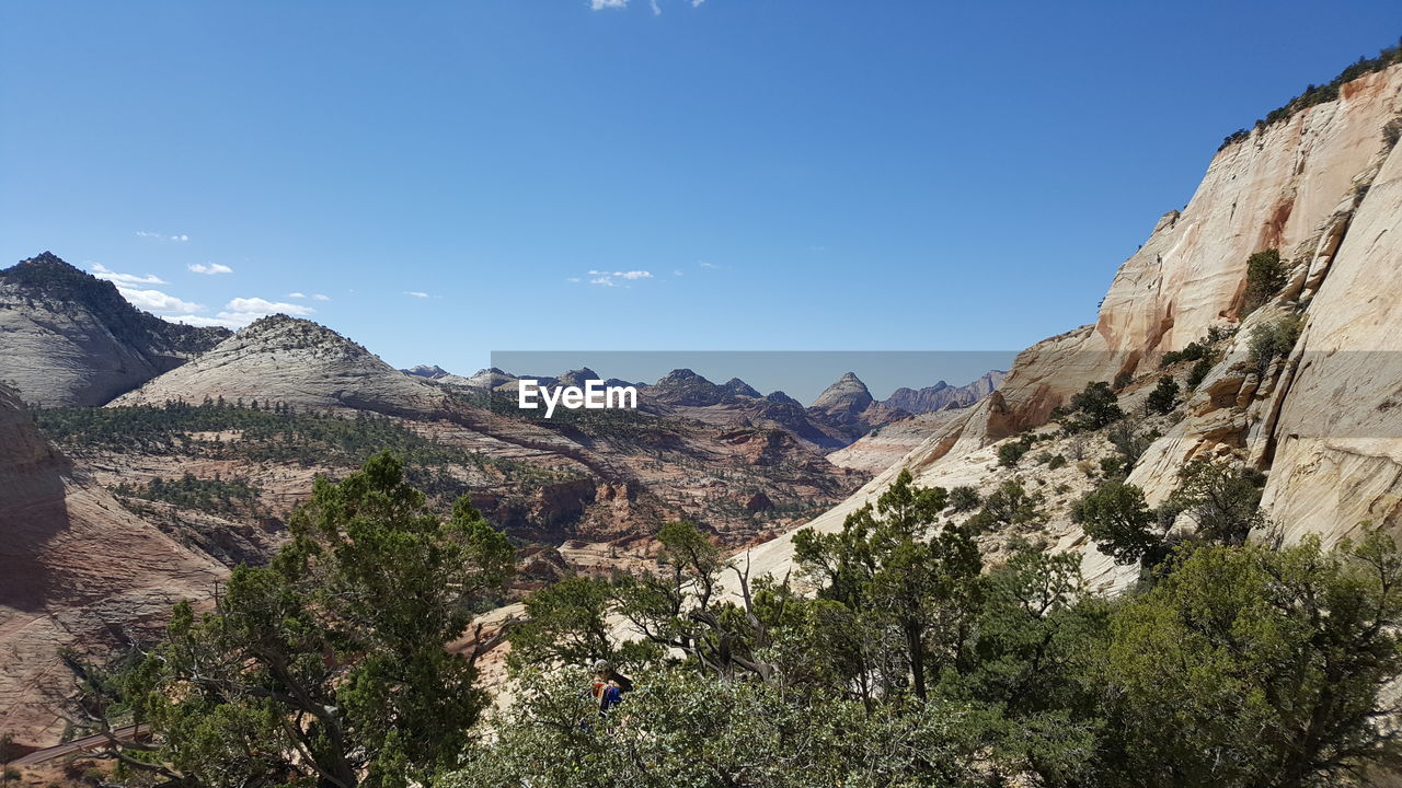 Panoramic view of mountains against clear blue sky