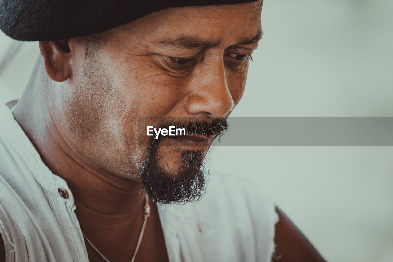 Close-up portrait of man wearing hat