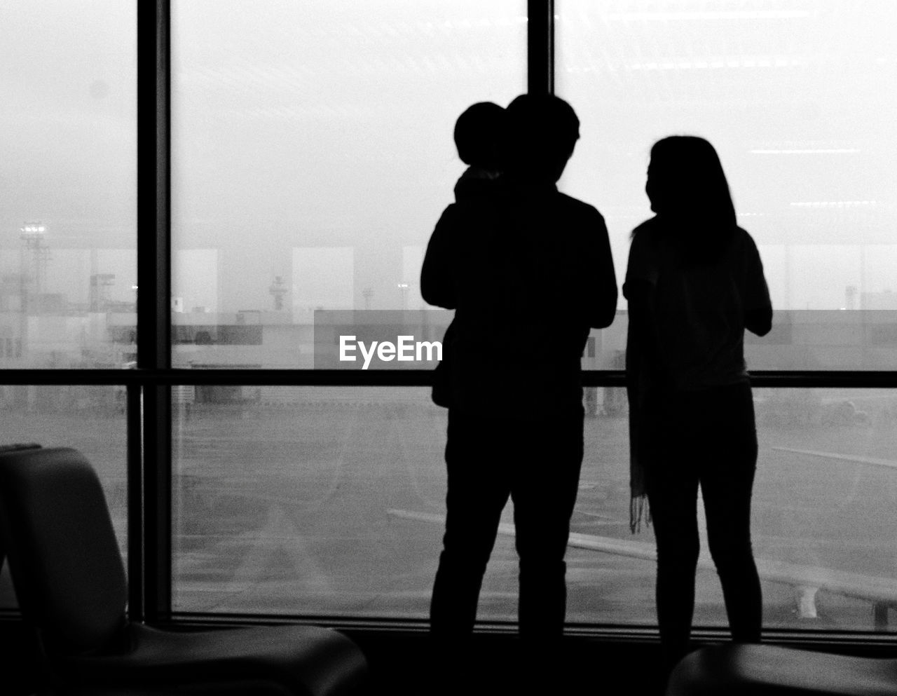 Rear view of silhouette family at airport