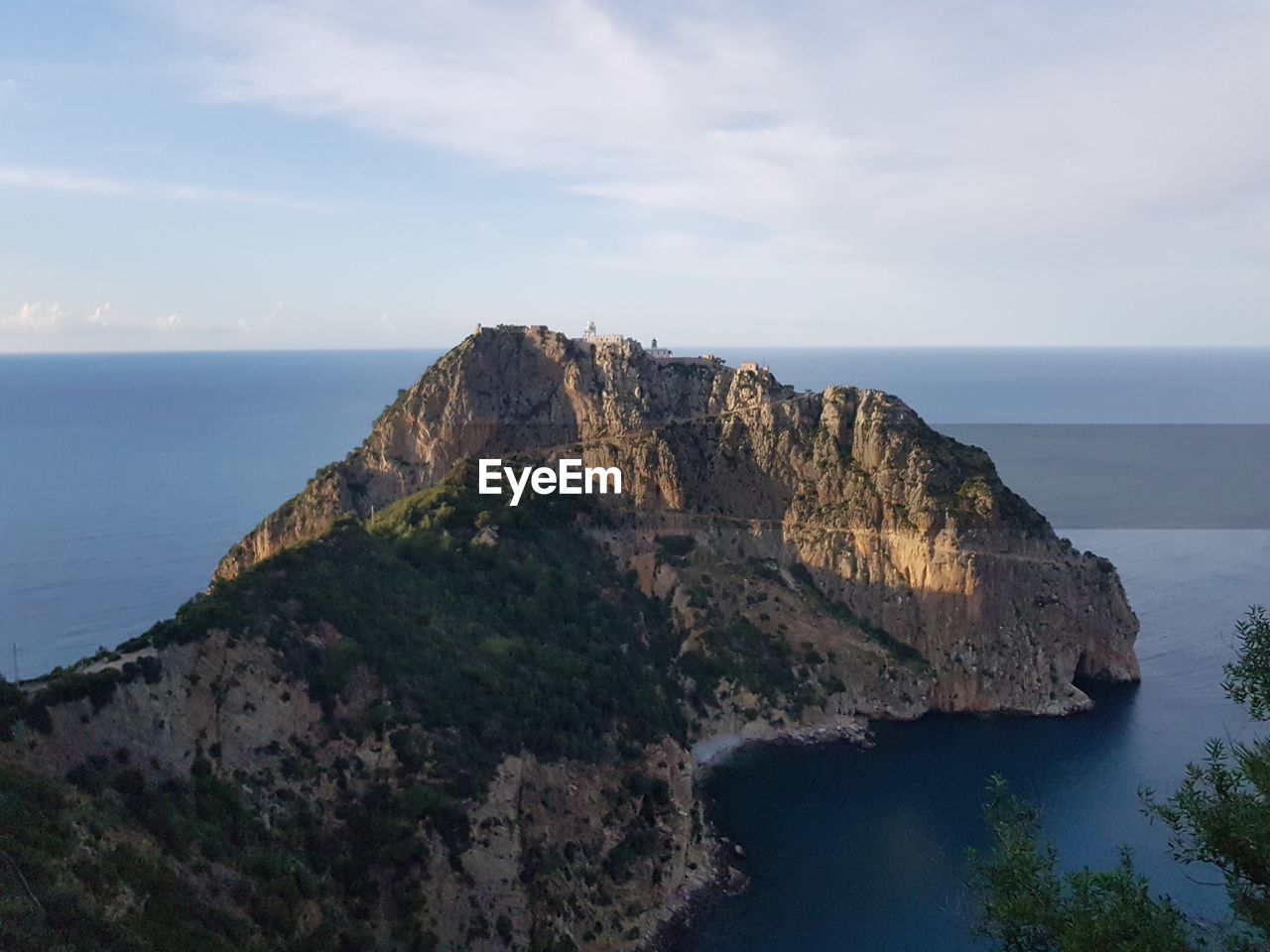 Rock formations by sea against sky