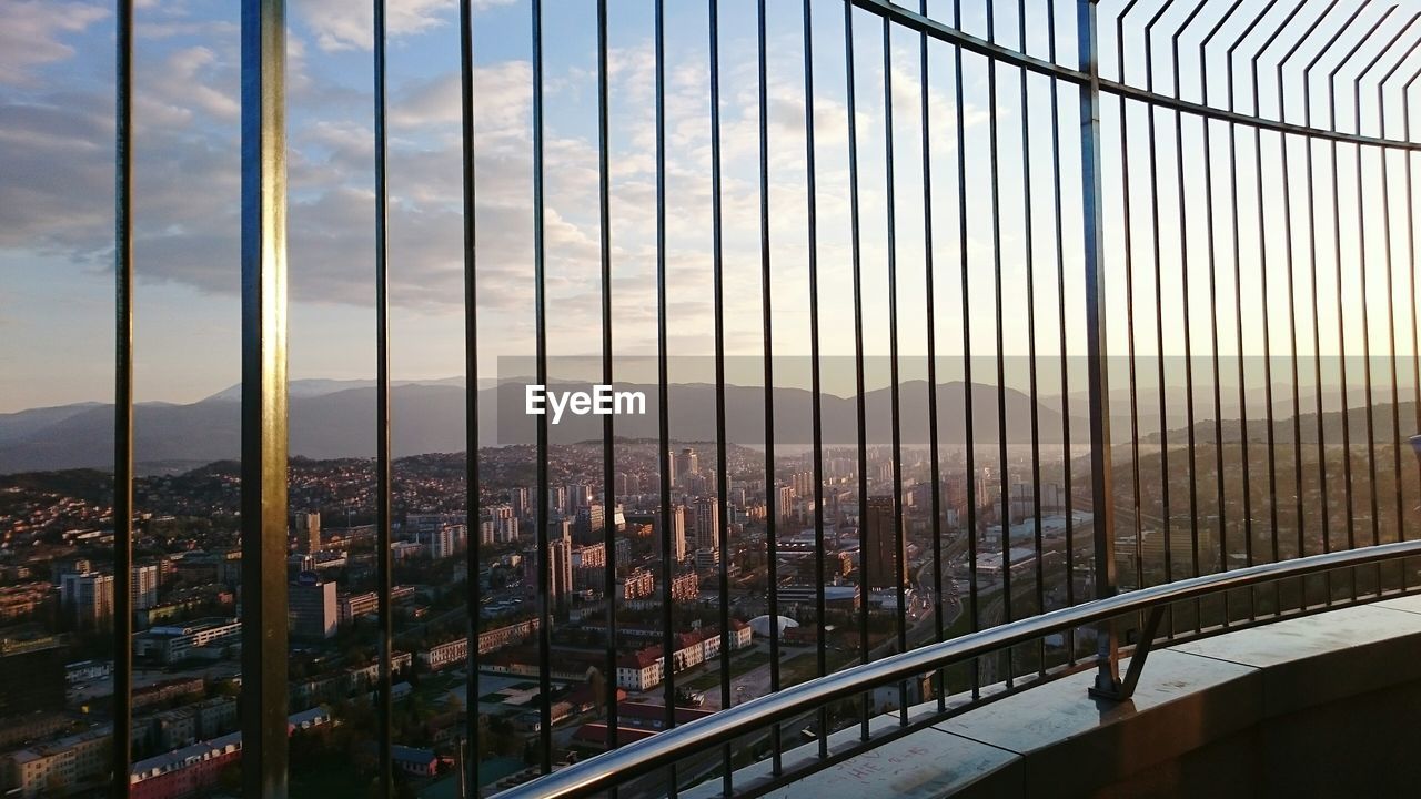 City viewed through railing of lookout tower