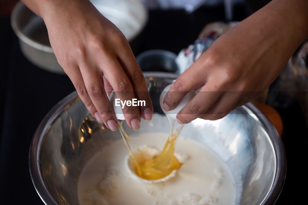 MIDSECTION OF WOMAN HOLDING ICE CREAM