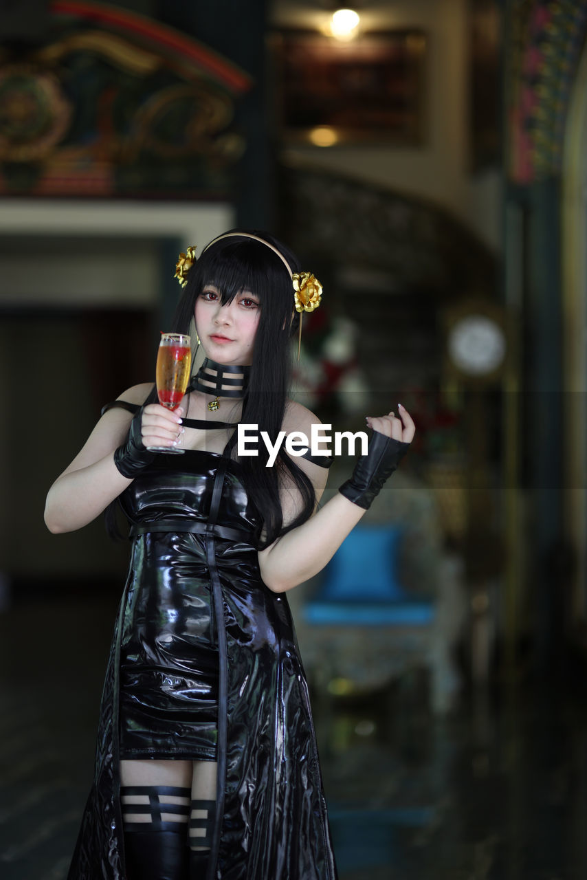 portrait of young woman drinking glass