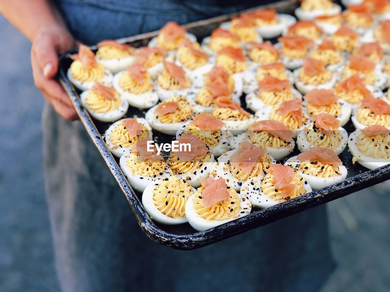 High angle view of person preparing food on tray