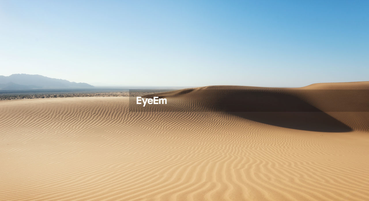 Scenic view of desert against clear sky