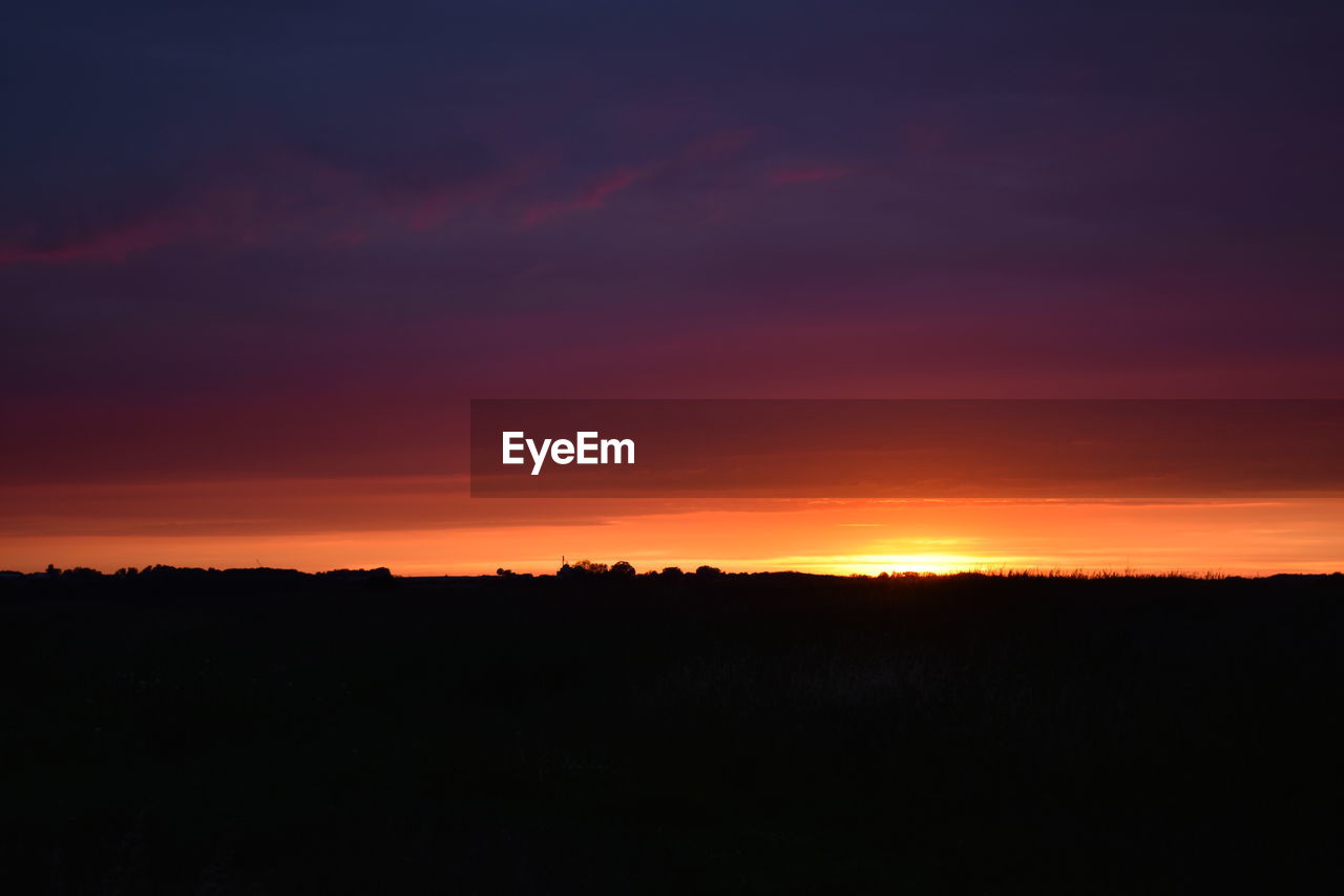 SCENIC VIEW OF SILHOUETTE LANDSCAPE AGAINST DRAMATIC SKY