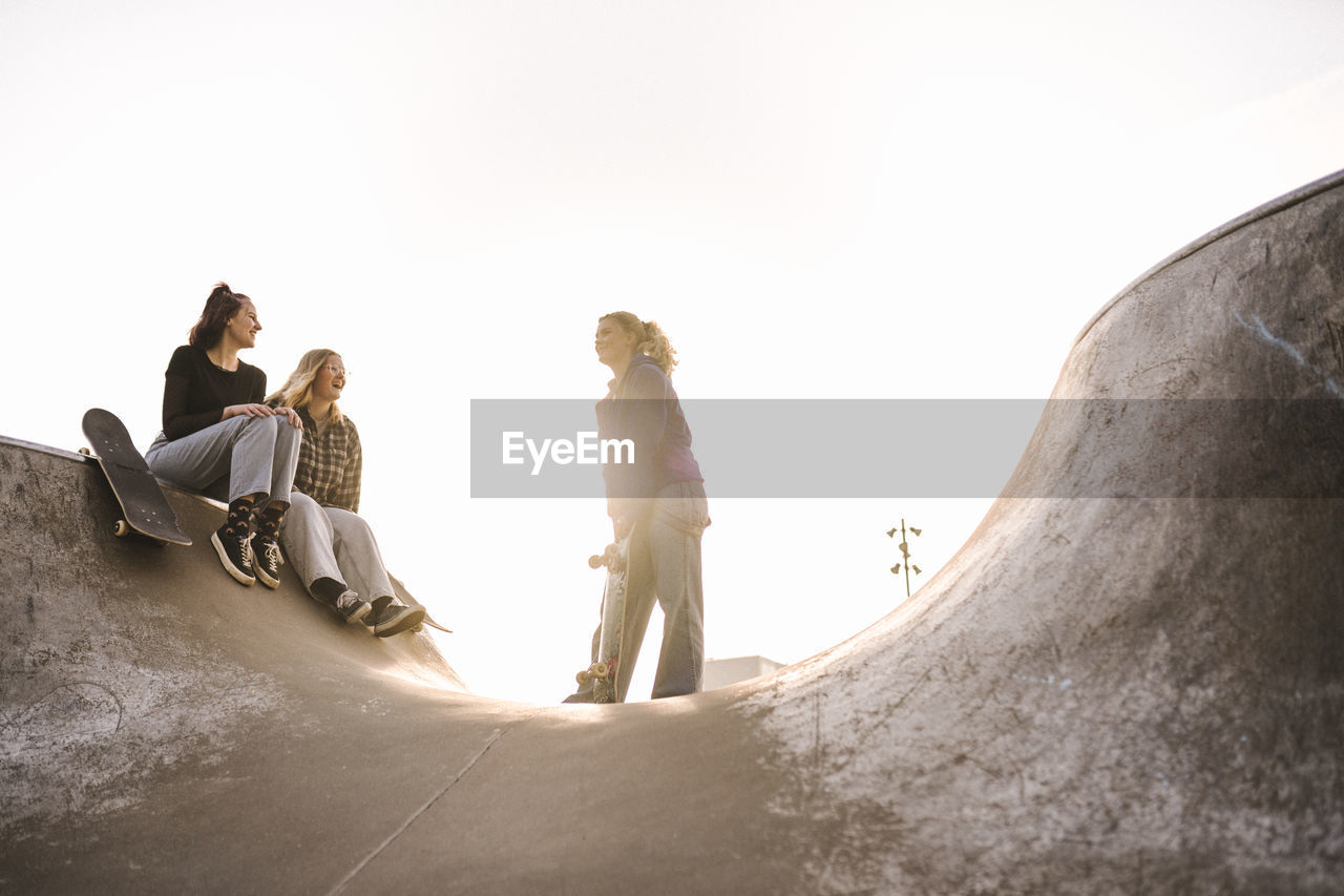 Teenage girls with skateboards in skatepark