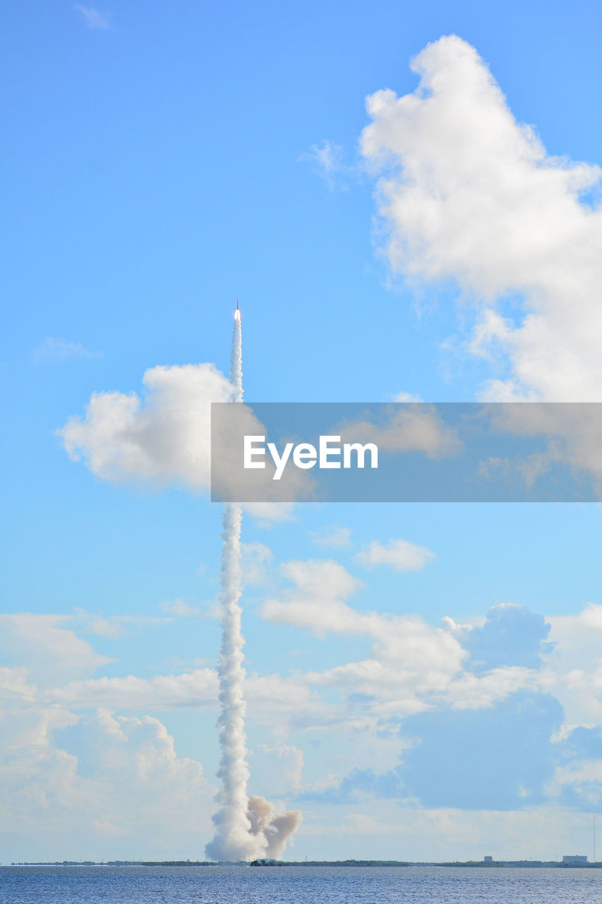 Low angle view of vapor trails against sky