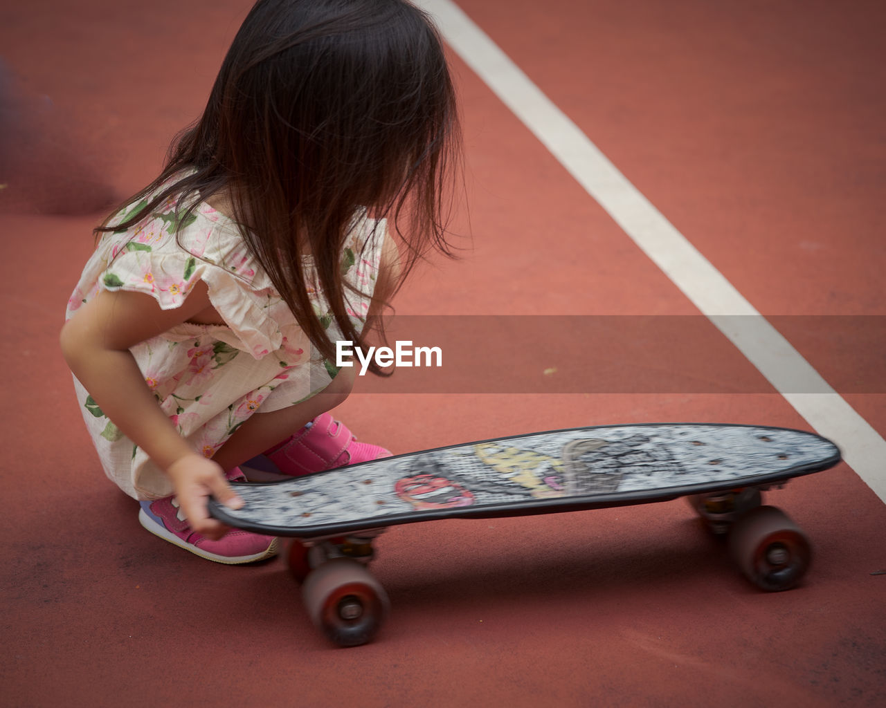 SIDE VIEW OF GIRL SKATEBOARDING