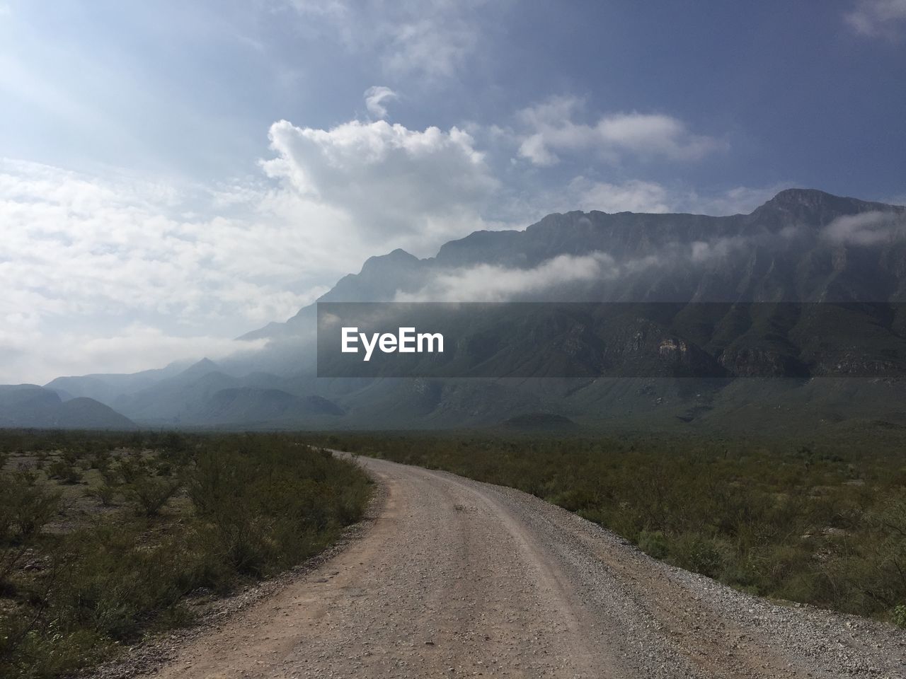 ROAD LEADING TOWARDS MOUNTAINS AGAINST SKY