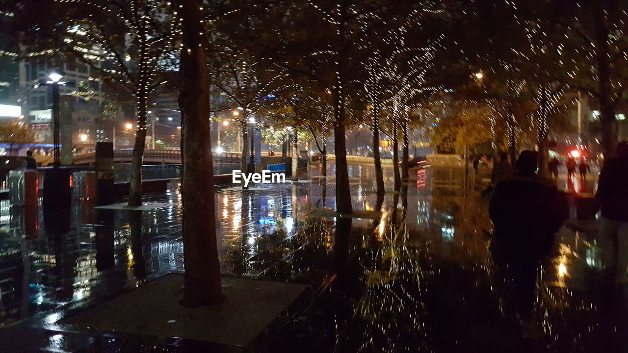 VIEW OF ILLUMINATED CITY DURING RAINY SEASON