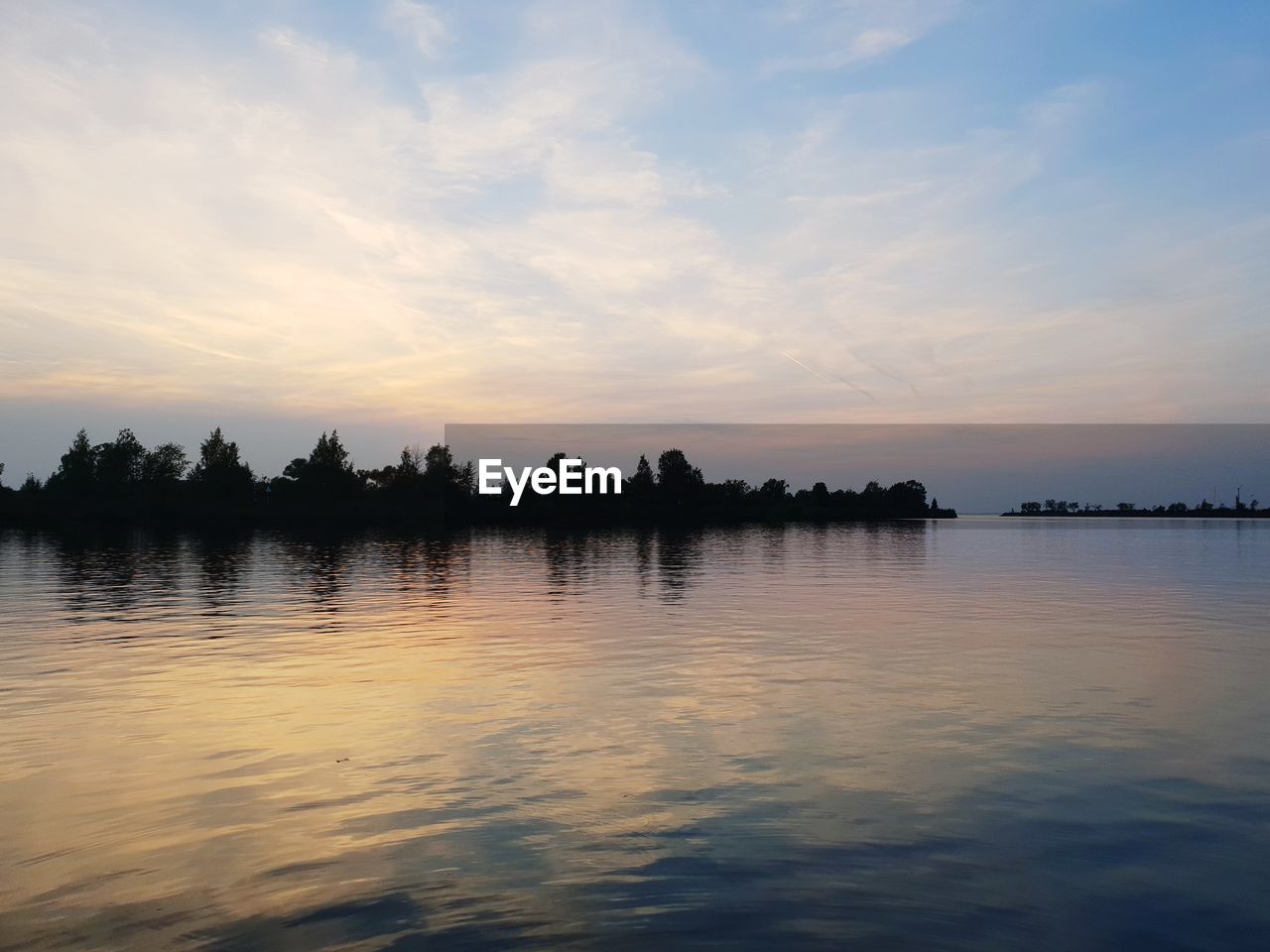 Scenic view of lake against sky during sunset