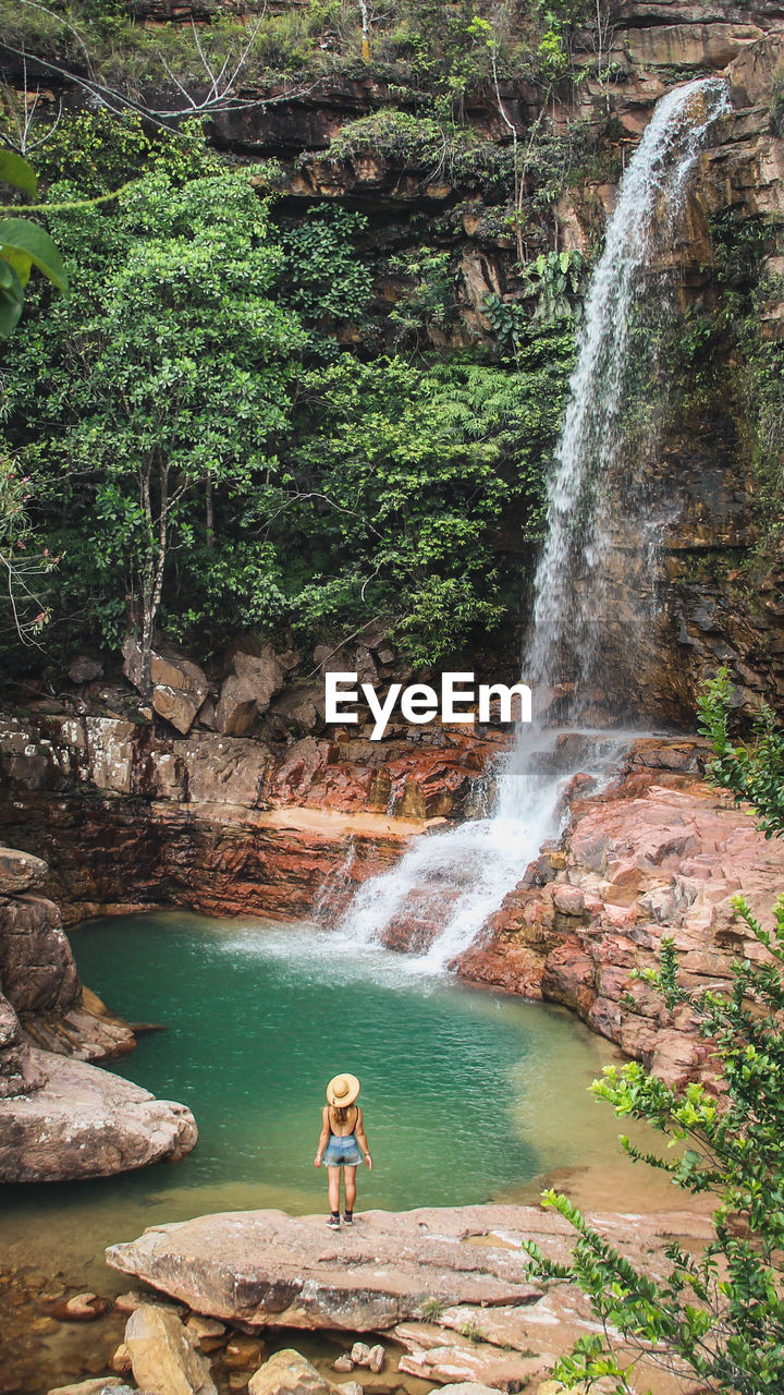 Rear view of man standing in waterfall in uiramutã, brazil
