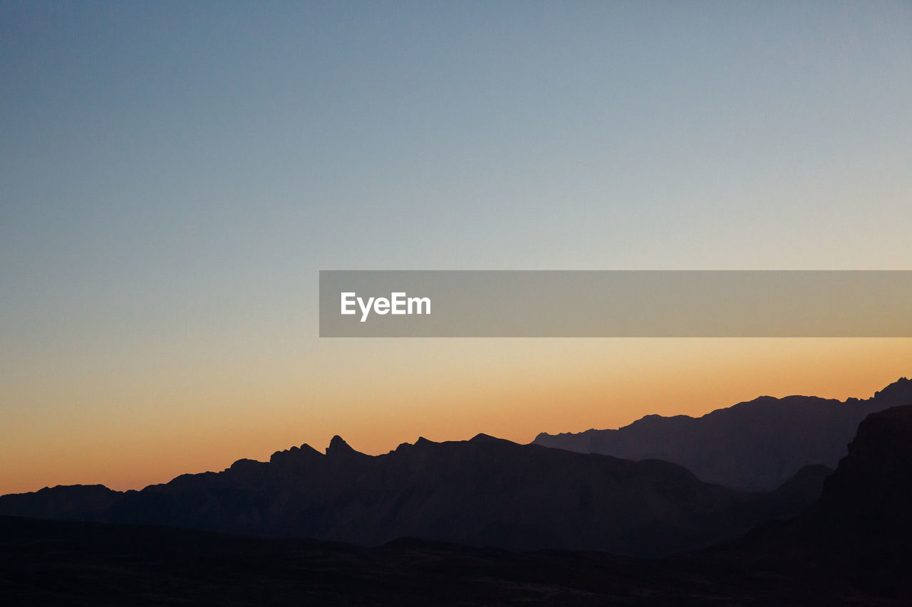 Scenic view of mountains at sunset