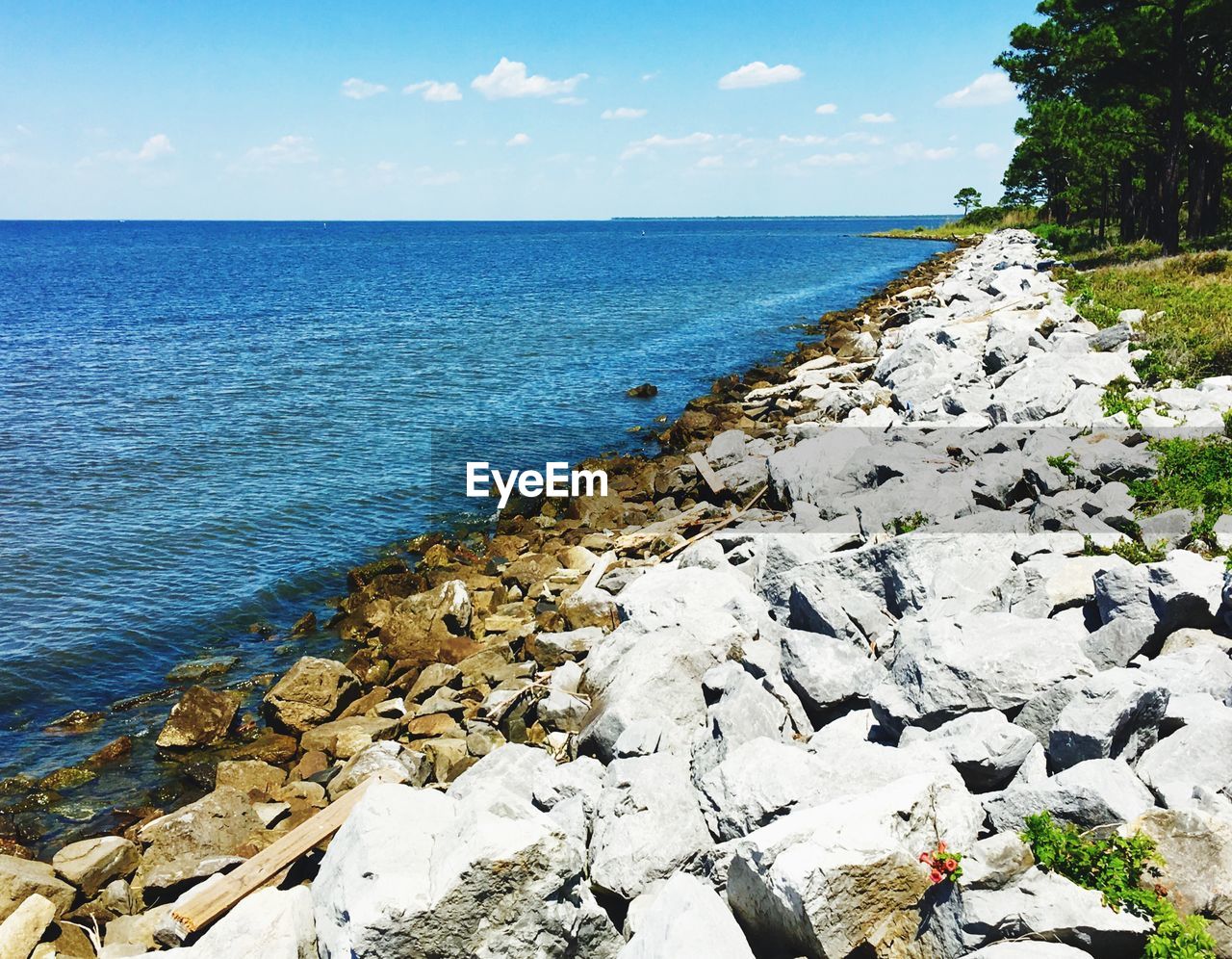 ROCKS IN SEA AGAINST SKY