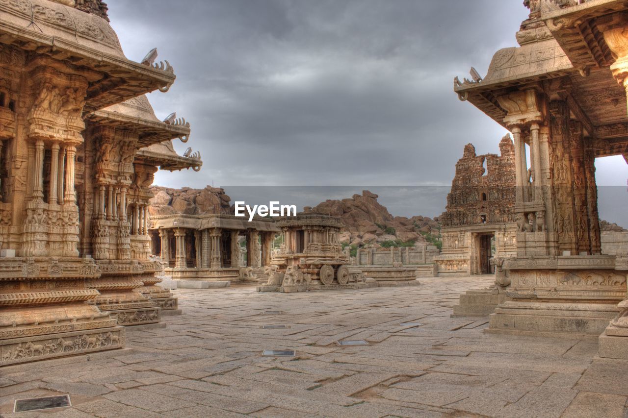 Historic temples against cloudy sky