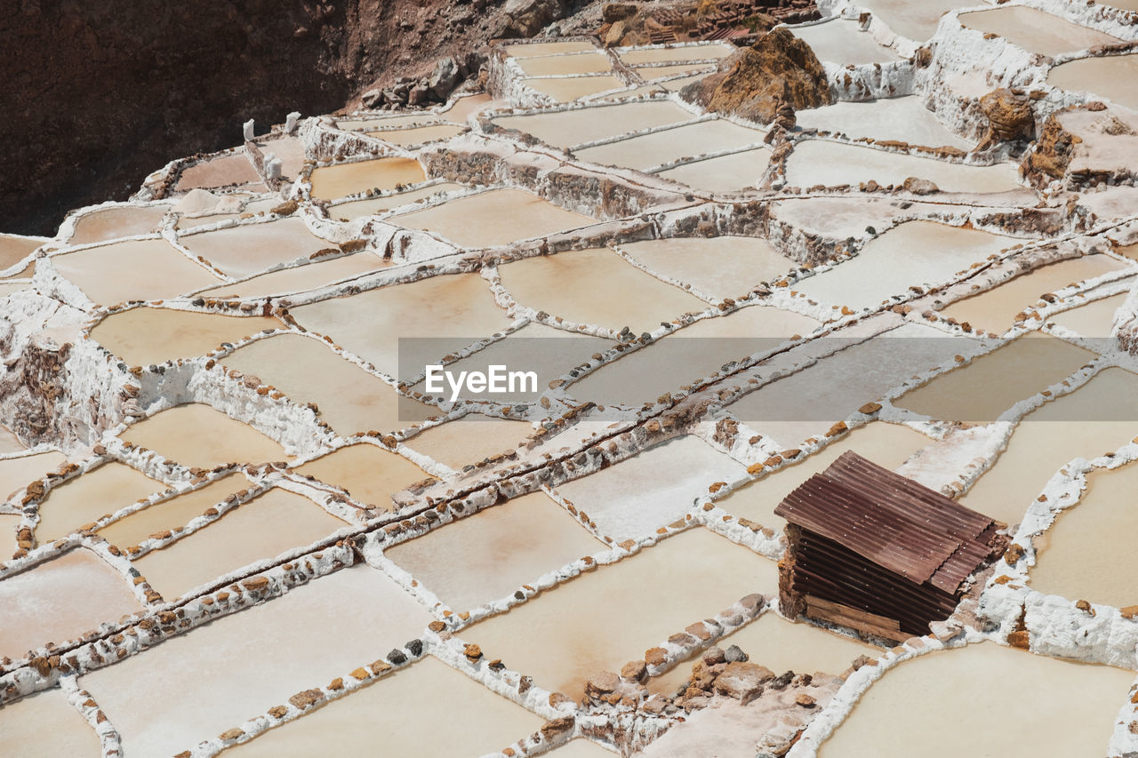 Little rusty warehouse in the middle of the pools at maras salt mine.