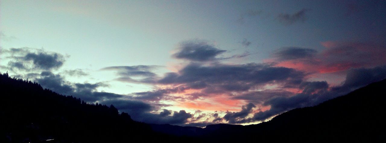 SCENIC VIEW OF MOUNTAINS AT SUNSET