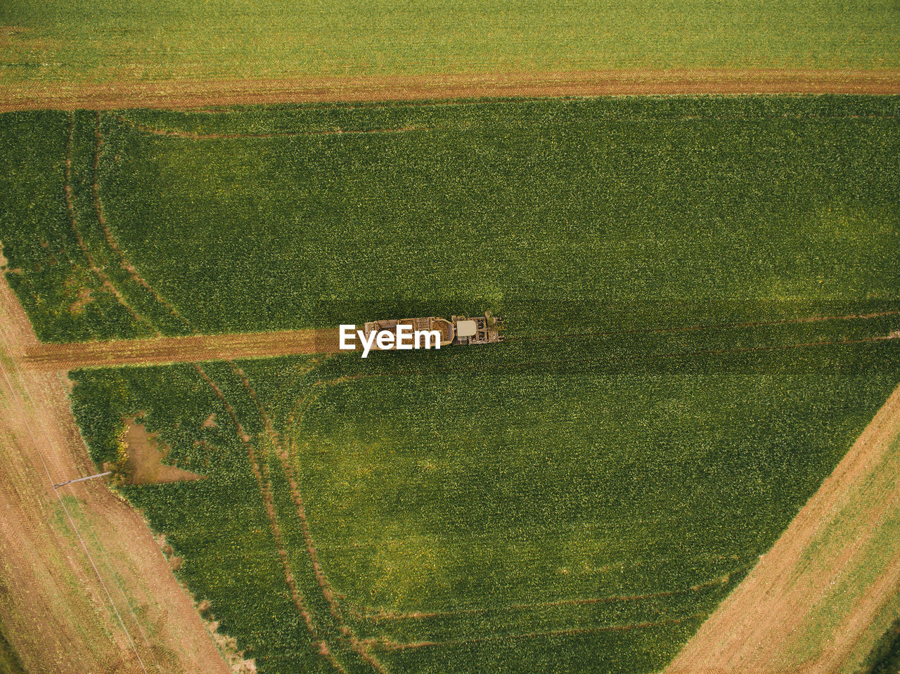 Aerial view of machinery working in agricultural field