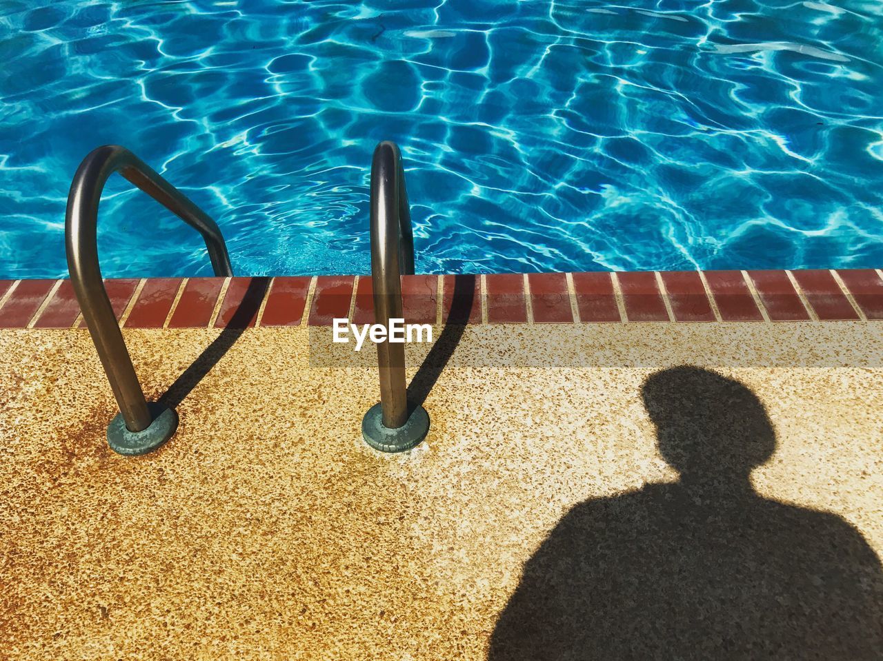 LOW SECTION OF MAN WITH SWIMMING POOL