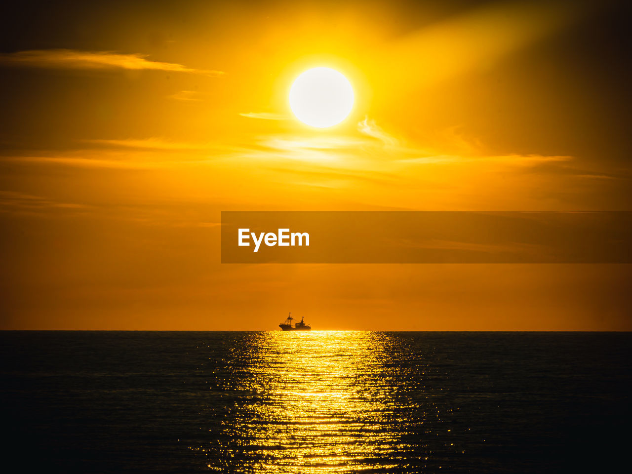 SCENIC VIEW OF SEA AGAINST ORANGE SKY DURING SUNSET