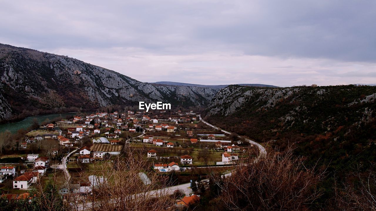 High angle view of houses and mountains against sky