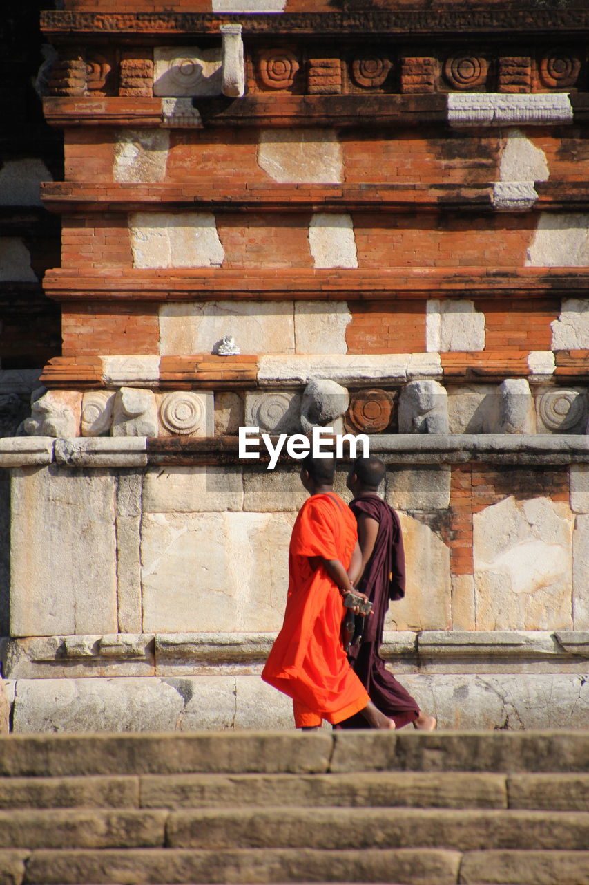 Low angle view of monks walking by temple