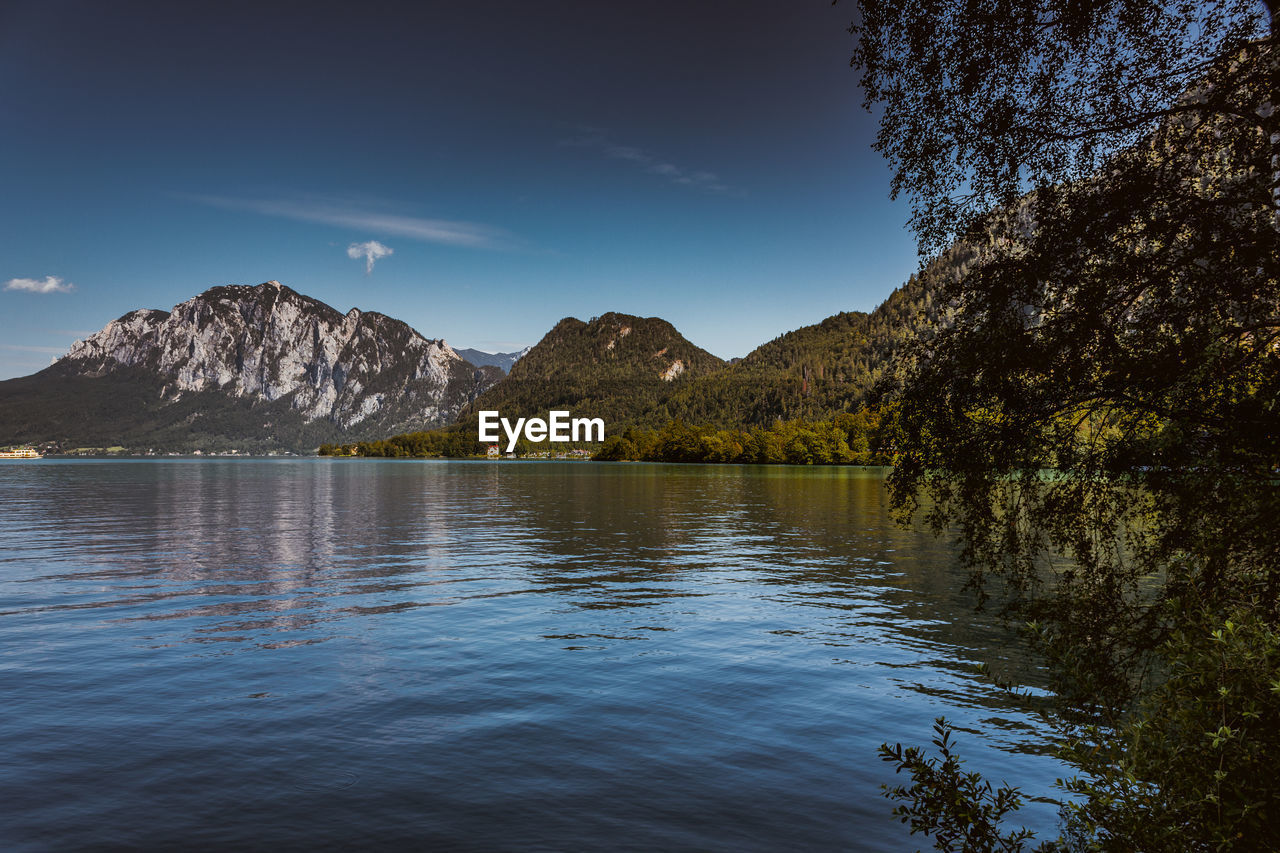 Scenic view of lake and mountains against sky