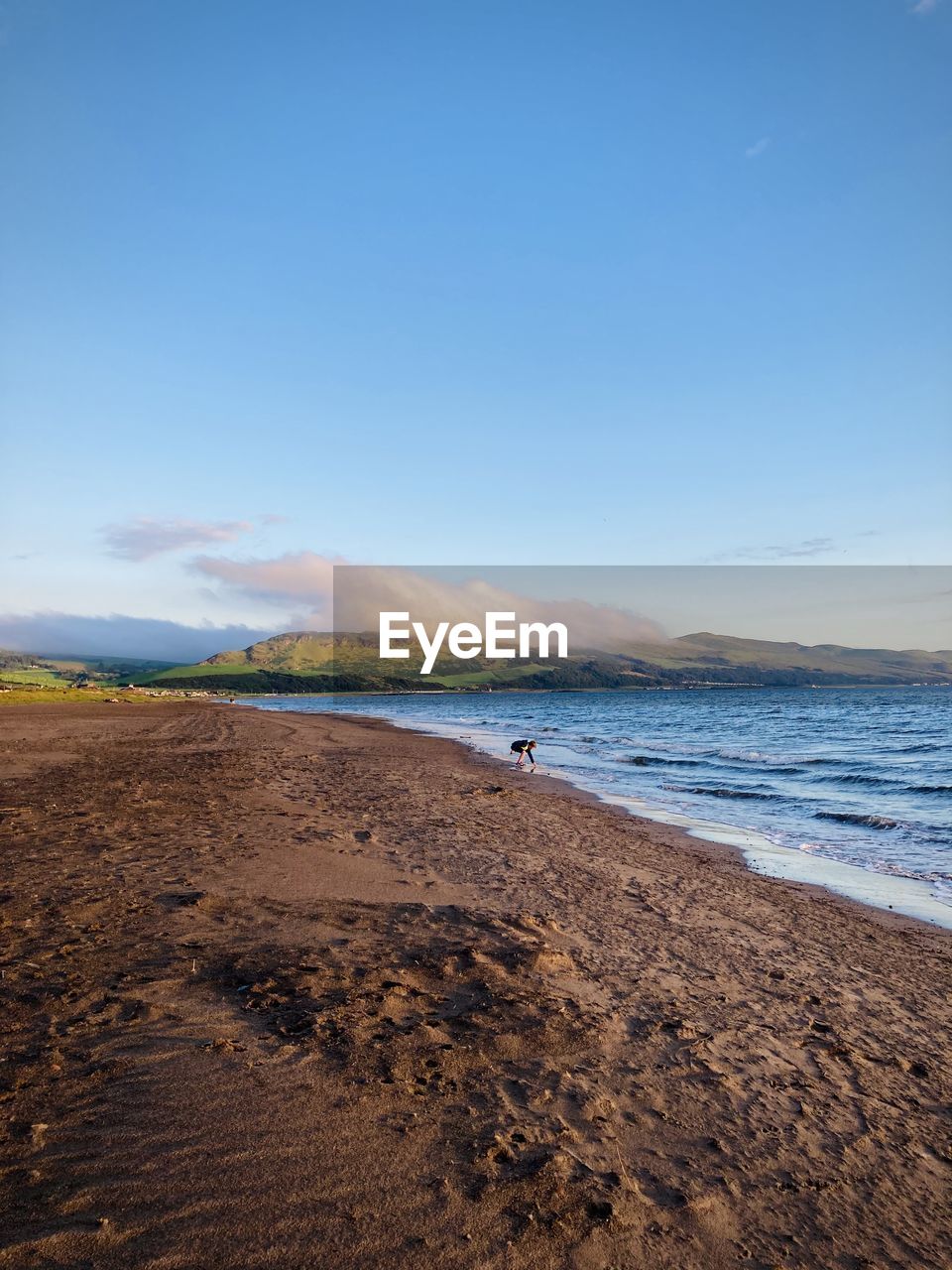 Scenic view of beach against blue sky