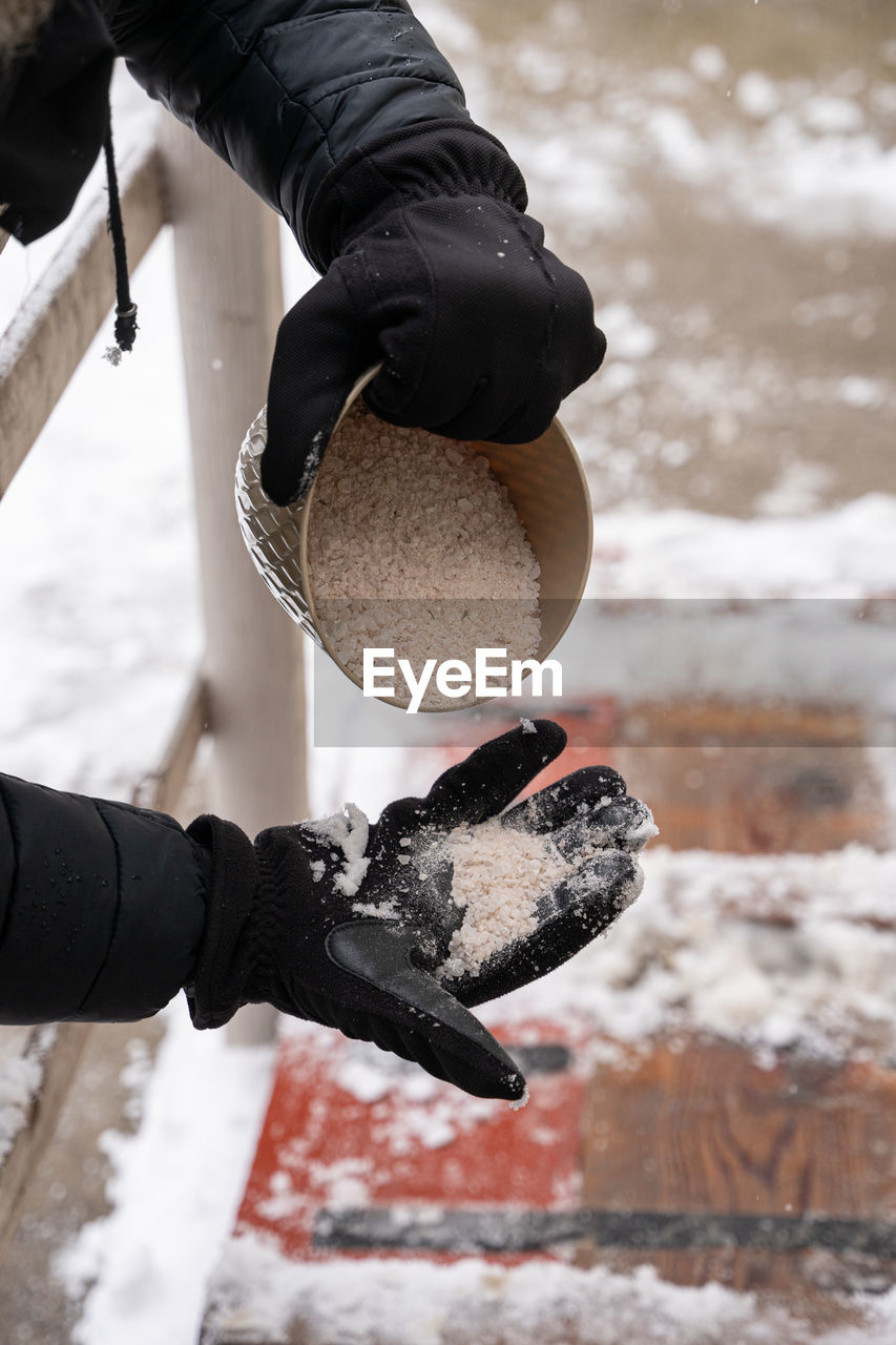 LOW SECTION OF PERSON WITH SNOW ON SHORE