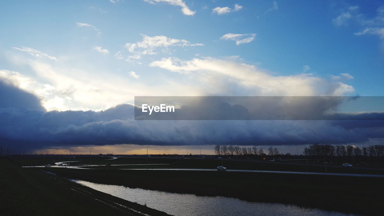 ROAD AGAINST CLOUDY SKY