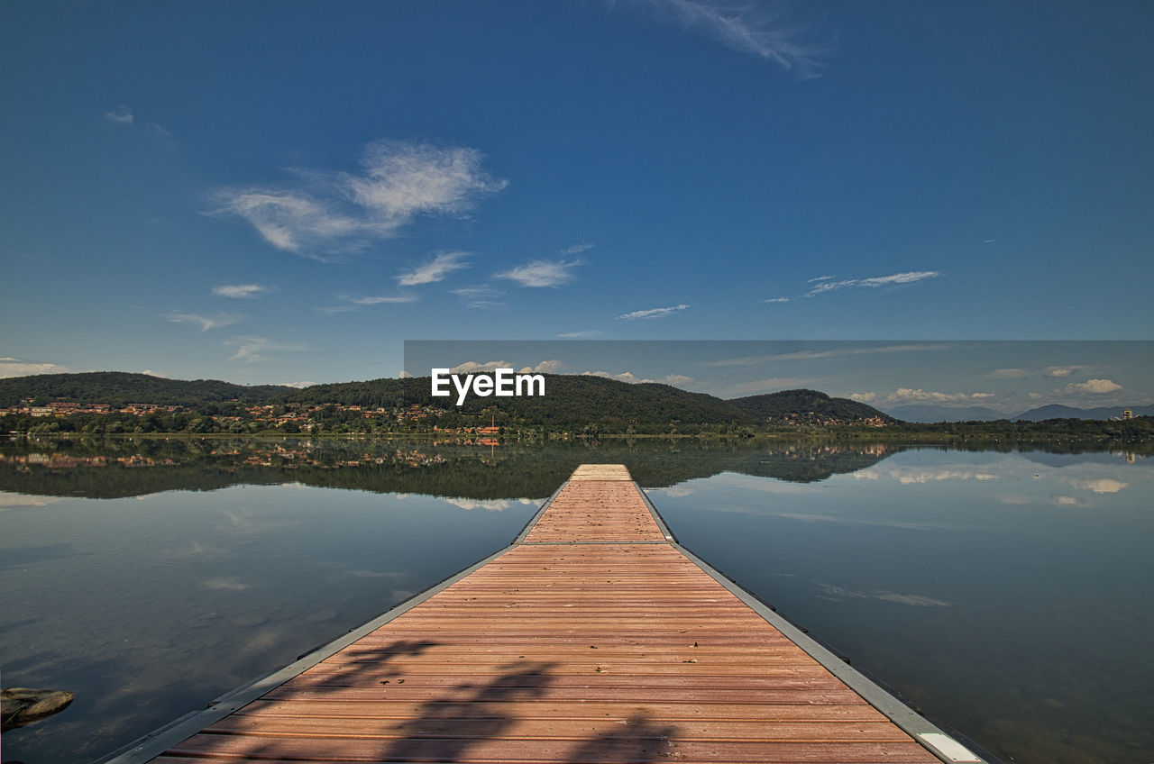 water, reflection, horizon, sky, lake, nature, scenics - nature, beauty in nature, environment, landscape, dusk, wood, tranquility, travel destinations, cloud, architecture, morning, mountain, pier, tranquil scene, land, sunlight, travel, no people, blue, built structure, coast, outdoors, jetty, transportation, beach, ocean, shore, summer, tourism, day, sunrise, trip, non-urban scene, idyllic, vacation, holiday, the way forward, clear sky, mountain range, urban skyline, coastline, sunny, boardwalk, nautical vessel