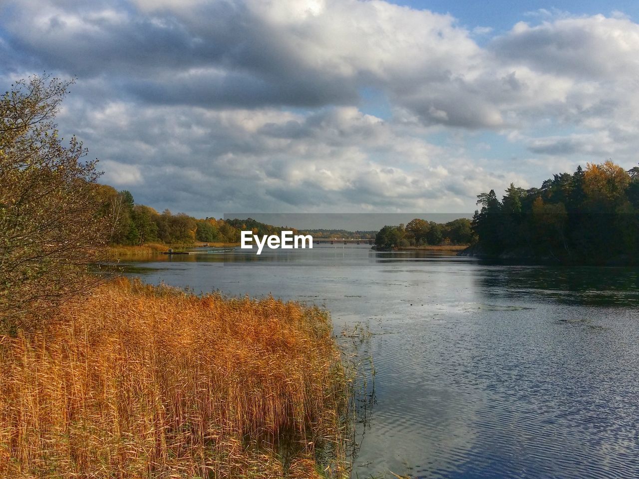 Cloudy sky above river 